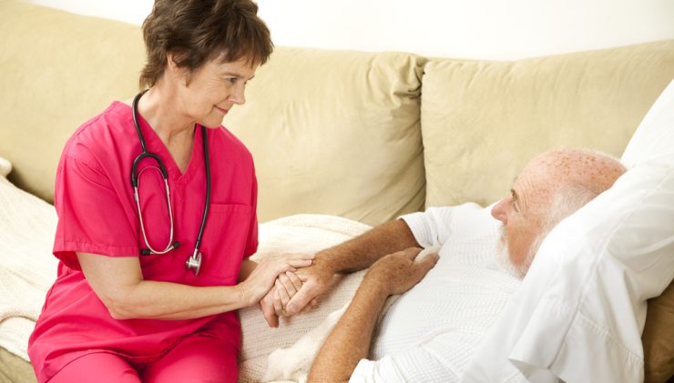 nurse helping elderly man